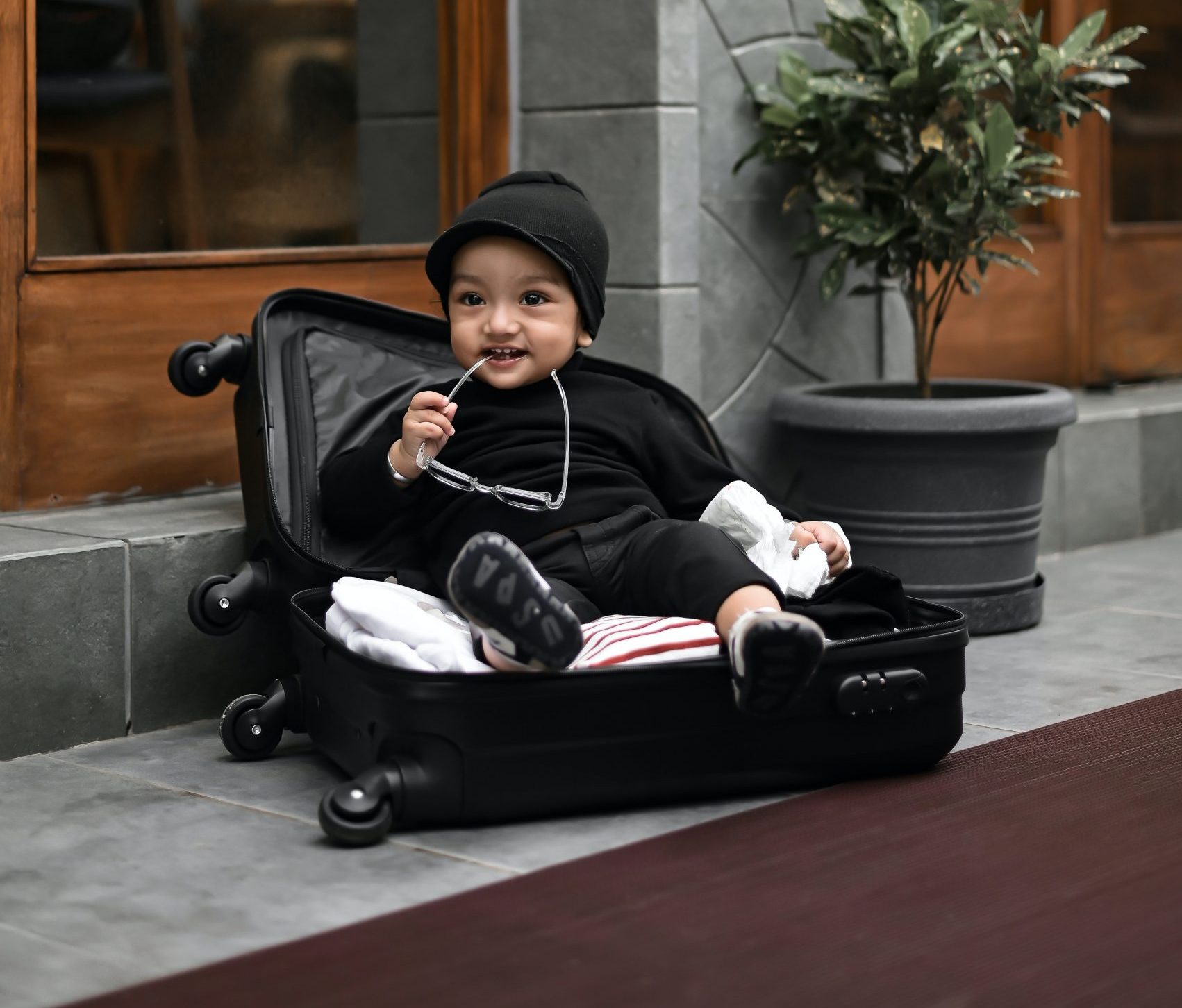 toddler chilling in the suitcase